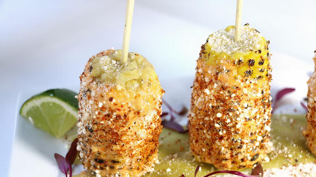 Elote · Grilled corn on the cob with chipotle mayo, cotija cheese & spicy chili.Gluten-Free. Vegetarian.