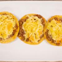Garnachas · Fried corn tortilla topping with ground beef  pickled cabbage homemade tomato sauce