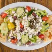 Greek Salad · romaine, tomatoes, cucumbers, red onions, peppers, dolma, kalamata olives and feta cheese se...