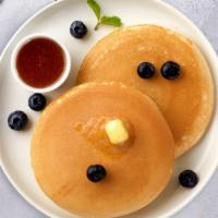 True Blue Pancakes · Fluffy pancakes cooked with care and love served with blueberries, butter and maple syrup. S...