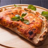 Meatball Calzone · Ricotta and Mozzarella Cheese, topped with meatballs, and stuffed and folded inside Pizza Do...