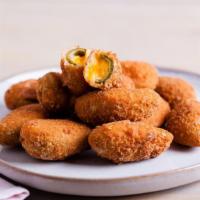 Cheddar Jalapeño Poppers · Juicy jalapeño poppers breaded and filled with cheese and fried to golden perfection.