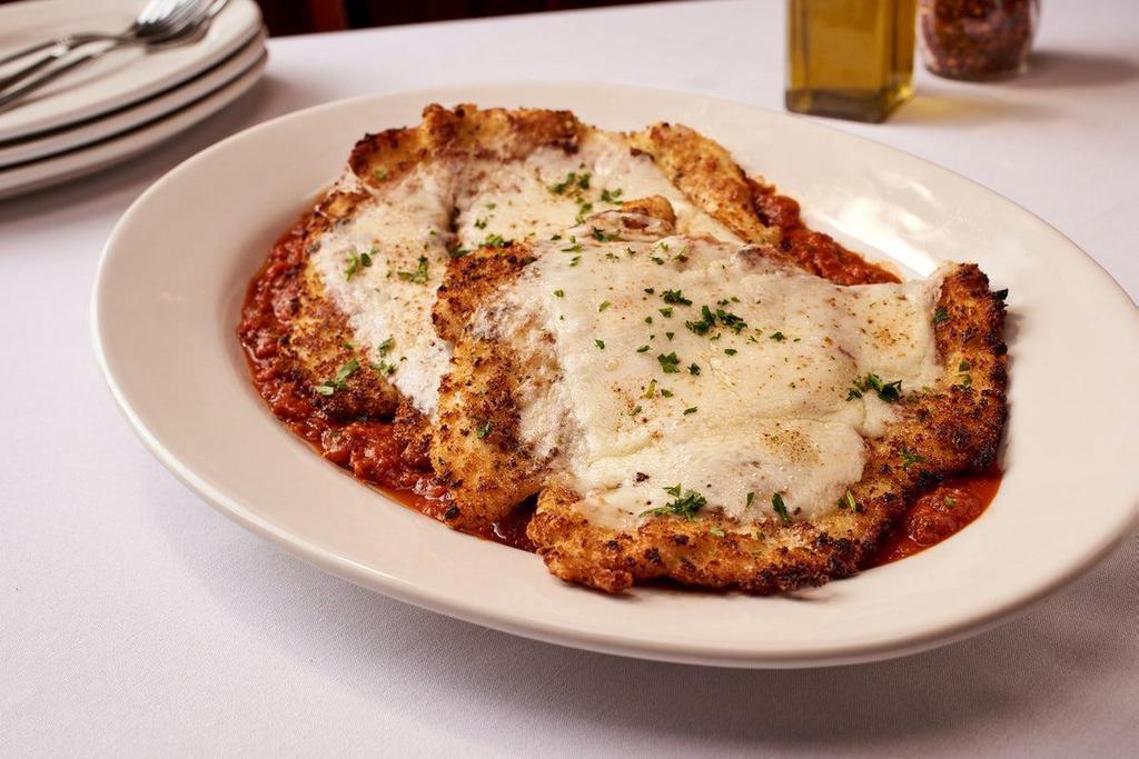 Veal Parmigiana · Breaded Thin Pounded Veal - Pan-Fried to a Crispy Golden Brown Topped with Melted Mozzarella - Served Over Marinara Sauce - Feeds 2-4
