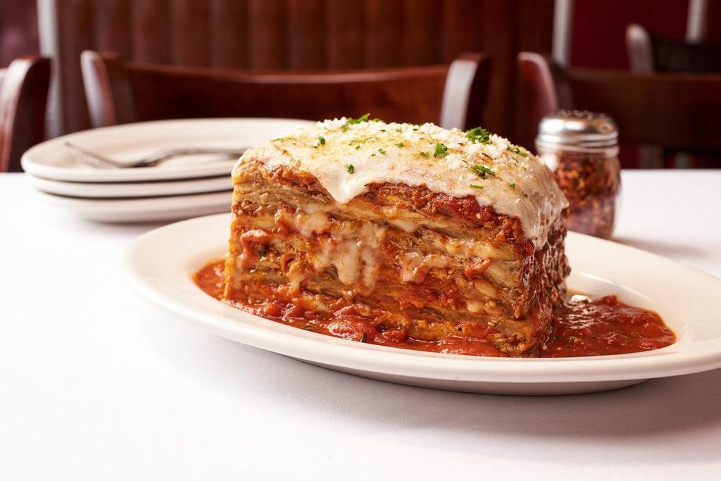 Eggplant Parmigiana · Lightly Battered & Fried Eggplant Thinly Sliced - Layered with Marinara Sauce, Mozzarella & Romano Cheeses Piled High Then Baked - Feeds 2-4