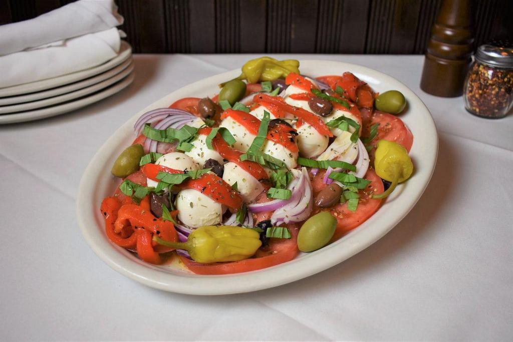 Caprese Salad · Tomato, Mozzarella, Black & Green Olives, Onions & Roasted Red Peppers Dressed w/ Oil & Vinegar