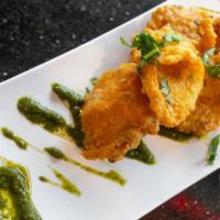 Amritsari Macchi · classic deep-fried fish seasoned with carom seeds, turmeric & Punjabi spices, served with mi...
