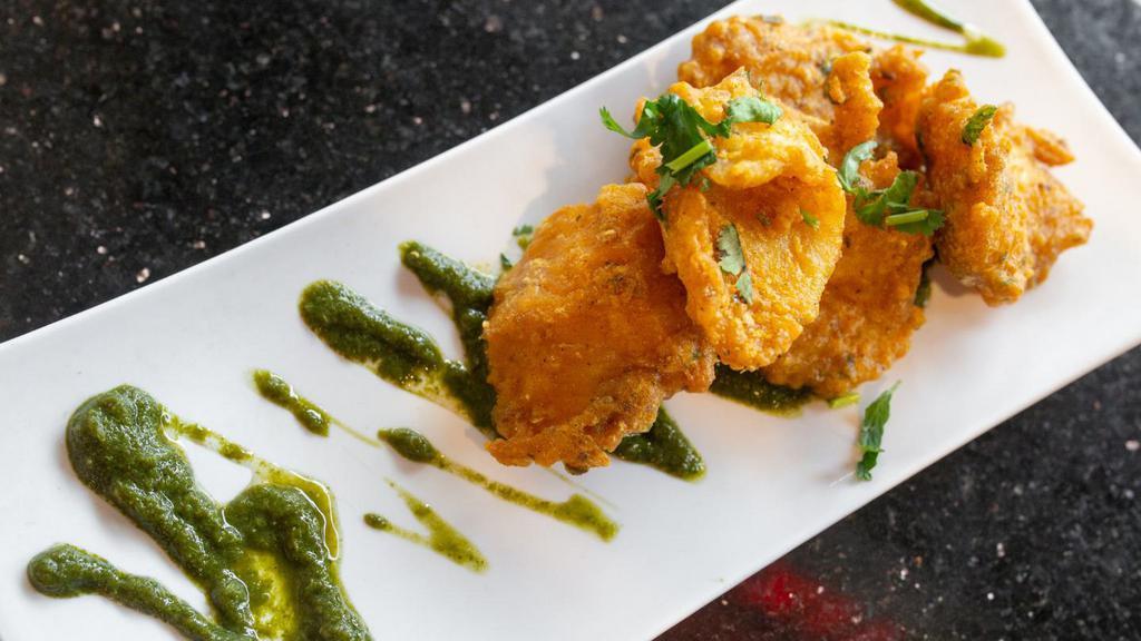 Amritsari Macchi · classic deep-fried fish seasoned with carom seeds, turmeric & Punjabi spices, served with mint chutney.