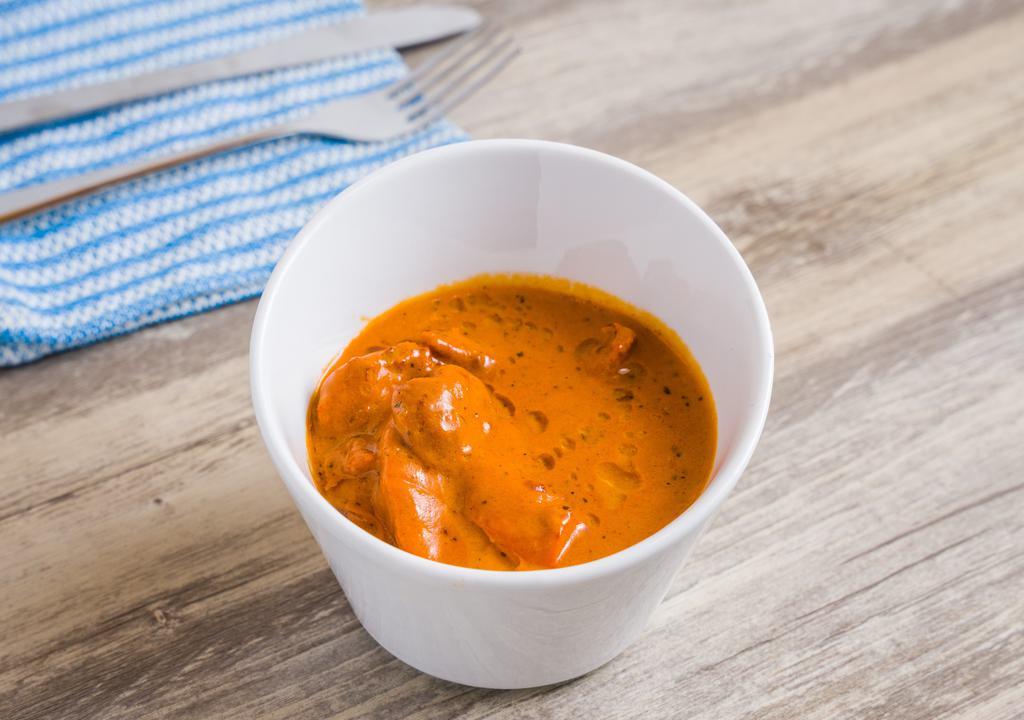 Butter Chicken · boneless chicken, marinaded and grilled in tandoor, finished in rich & mildly spiced tomato gravy.
