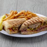 Santeria · Our take on a traditional Cuban, with pork loin, slow-roasted in-house, ham, melted Swiss ch...