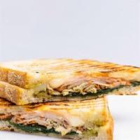 Turkey And Sun-Dried Tomato Panini · Sliced Roasted Turkey, Provolone, Spinach, Sun-Dried Tomato Spread, and House Pesto on Sourd...