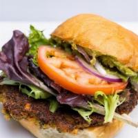 Veggie Burger · Falafel Patty, Chimichurri, Avocado, Harissa Hummus, Leafy Greens, Tomato and Red Onion on a...