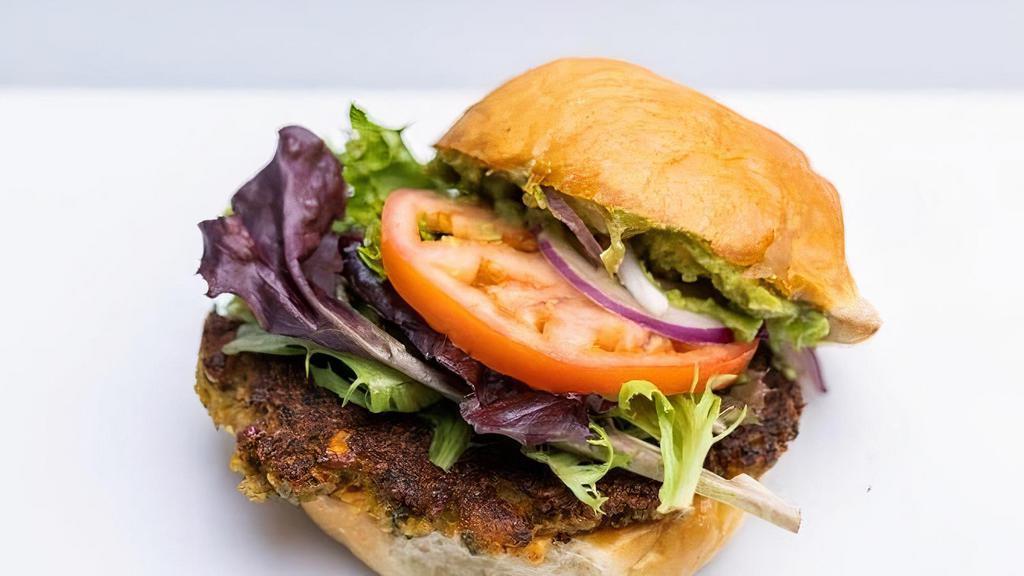 Veggie Burger · Falafel Patty, Chimichurri, Avocado, Harissa Hummus, Leafy Greens, Tomato and Red Onion on an Artisan Bun. Served A la Carte.