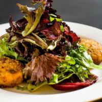 Warm Pistachio Goat Cheese Salad · Goat cheese crusted with pistachio nuts and served over mixed greens, with a citrus vinaigre...