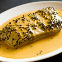 Steak Au Poivre · New York strip, coated with black peppercorns, sautéed, flamed in cognac, and served in dijo...