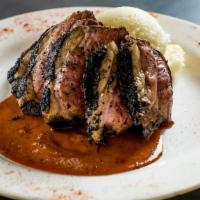 Blackened Lamb Sirloin · Spiced lamb sirloin, seared and sliced over mashed potatoes with a bar-b-q glaze.