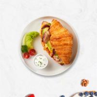 Meaty Egg Croissant · Your choice of meat with scrambled egg and cheese served on buttery croissant.