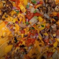 Jerk Nachos · Jerk chicken, black bean, corn, jalepeno pepper, red onion,. pineapple mango salsa, and shre...