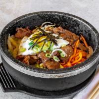 Marinated Pork Dolsot Bi Bim Bap 돼지갈비 돌솥 비빔밥 · Rice topped with vegetables, marinated pork and egg