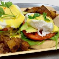 Garden Veggie Benedict · Two poached eggs served on a bed of spinach, tomatoes, and avocado traditionally served on t...