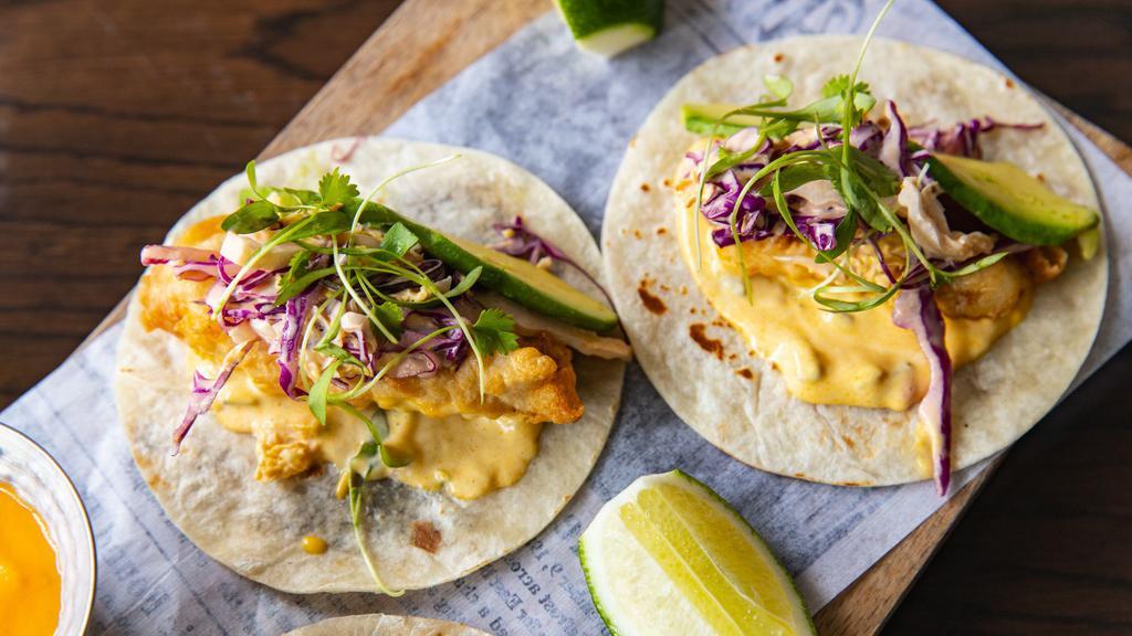 Fish Tacos · beer battered - napa chipotle cabbage slaw - avocado (contains dairy)