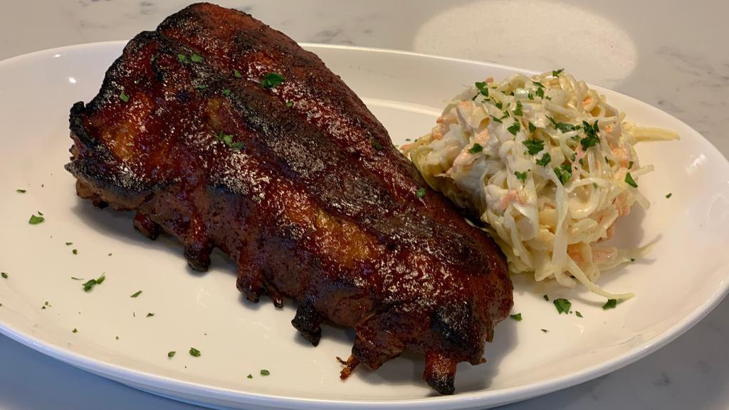 Baby Back Ribs · BBQ sauce served with cole slaw