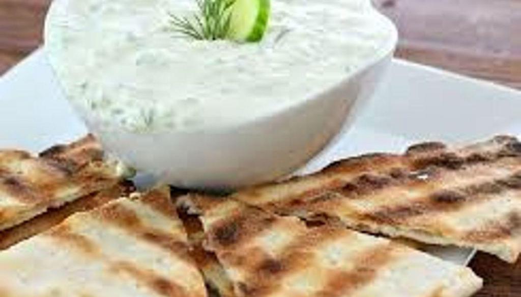 Tzatziki Dip · Greek original!  Yogurt, garlic, dill, and cucumber.  Goes great with anything!  (Does not come with pita)
