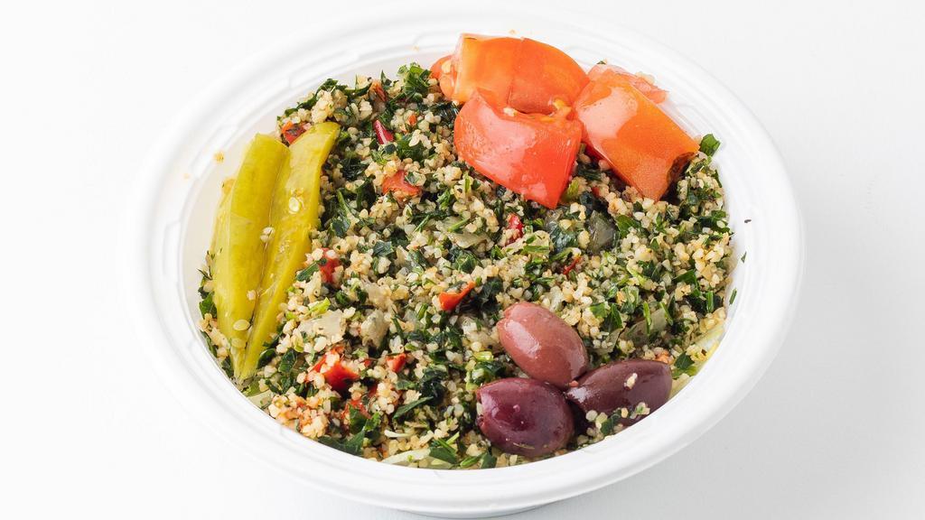 Tabouleh Salad · Bulgur wheat salad mixed with finely chopped mint, parsley, garlic, onions, and peppers; garnished with tomatoes, pickles, pickled turnips, olive oil, and lemon juice