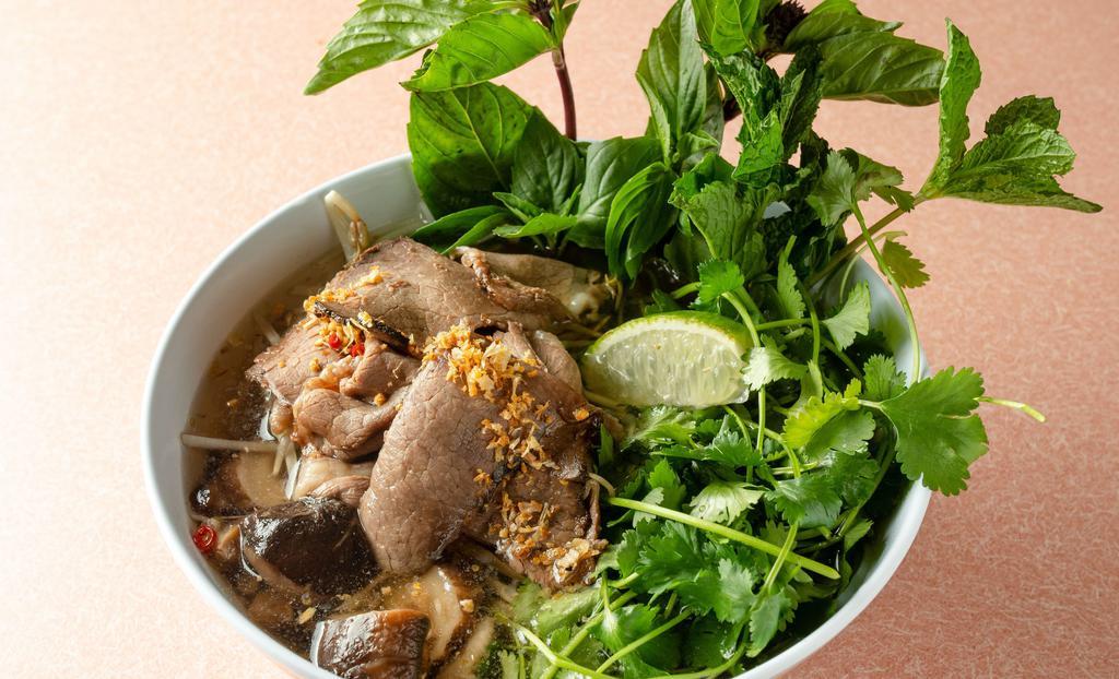 Smoked Brisket Pho Soup · Clear broth with vermicelli rice noodle, bean sprouts, shiitake mushroom, basil, cilantro, mint, fried garlic chips, Thai chili, and lime.