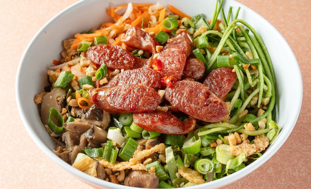 Chinese Sausage Bowl · Vermicelli rice noodle, chopped lettuce, cucumber, bean sprouts pickled daikon and carrot, scallion, Thai chili, shiitake mushrooms, crushed peanuts, and fried onion with a side of housemade vegan fish sauce.