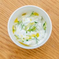 Tzatziki · Strained greek yogurt spread with cucumber garlic herbs and extra virgin olive oil.
