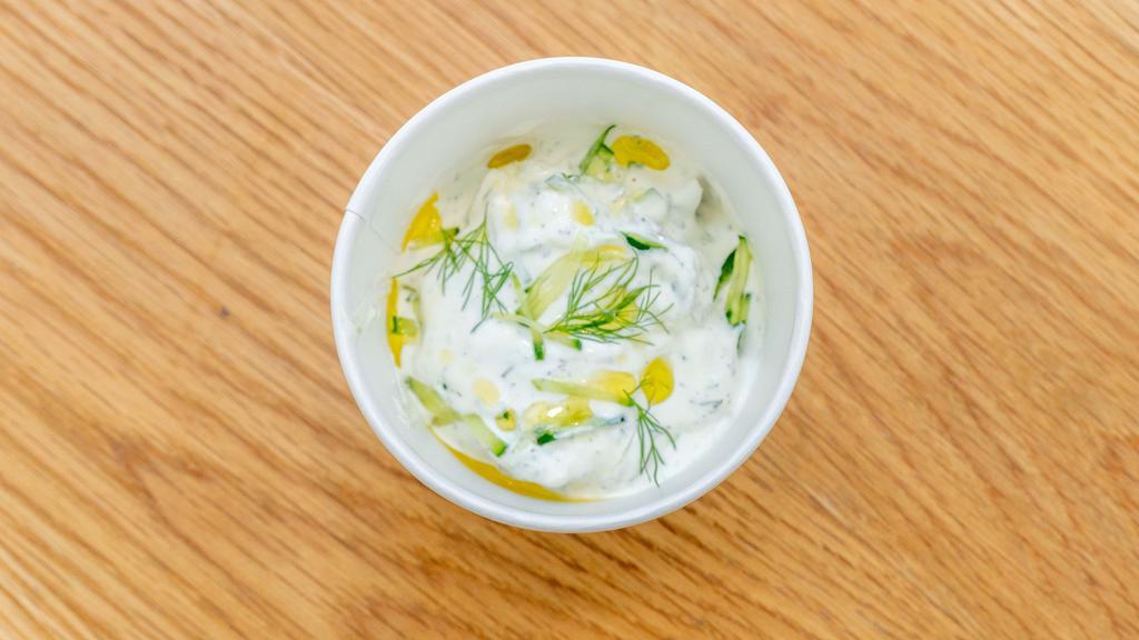Tzatziki · Strained greek yogurt spread with cucumber garlic herbs and extra virgin olive oil.