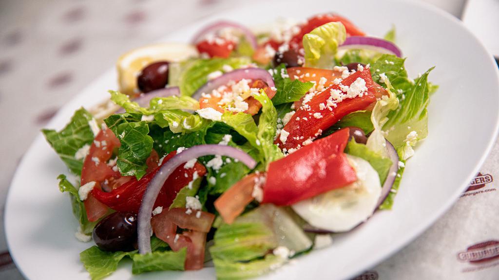 Signature Greek Salad · Fresh romaine lettuce, vine ripened tomatoes, feta cheese, sliced cucumbers, red onions, kalamata olives, peppers and our Greek dressing.