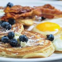 Golden Brown Pancakes With Eggs And Meat · 3Pcs Pancakes, 2 Eggs any style, Bacon, Ham or Sausage.