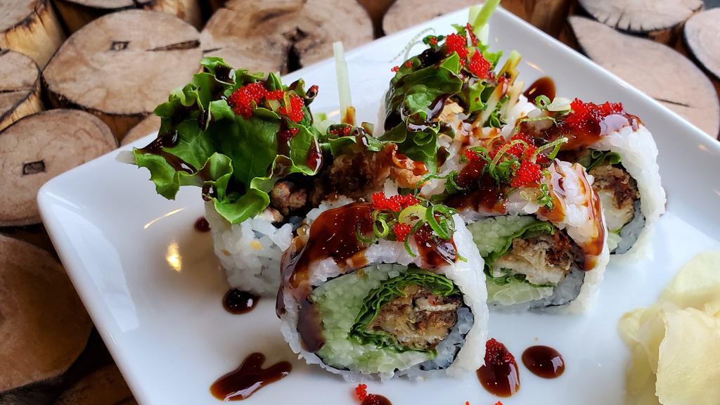 Spider Roll · Fried soft shell crab, avocado, cucumber, lettuce and mayo top with eel sauce, scallion and caviar.