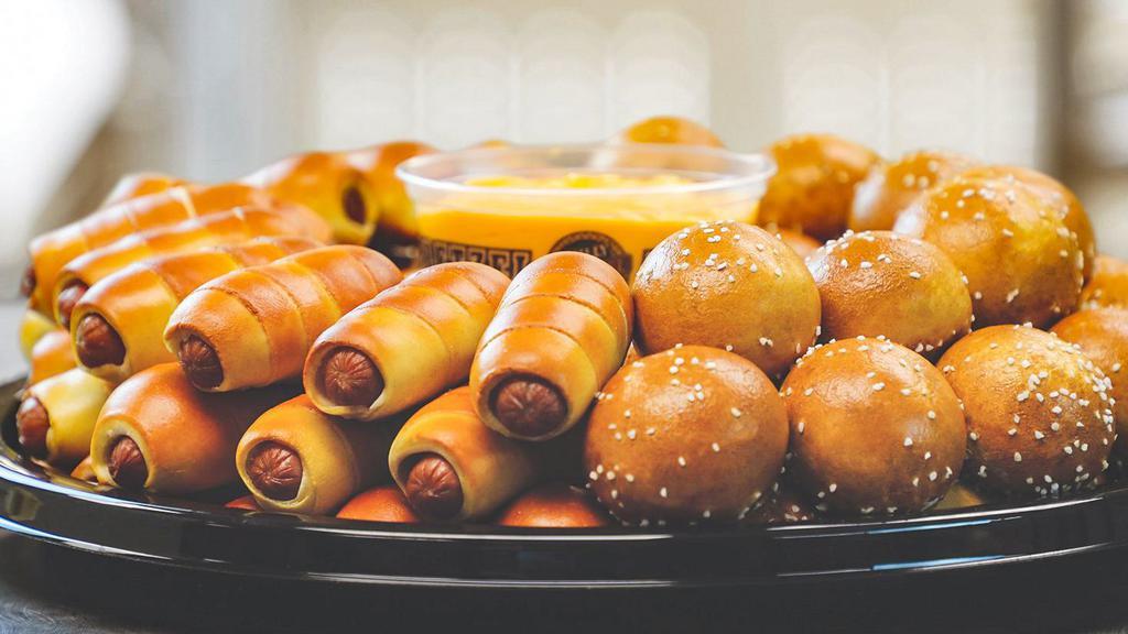 Party Tray -Mini Chz Steak & Mini Dog · Can it get any better?! 36 Mini Cheesesteaks and 36 all-beef Mini Pretzel Dogs with American cheese plus any 2 of our dips. Serves approximately 20-25 guests.