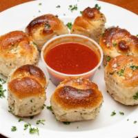 Go Go Garlic Knots · Savory bite sized tender dough twists slathered in garlic olive oil and baked golden brown w...