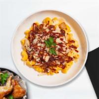 Bbq Chicken Mac · Caramelized onions, BBQ cheese sauce, and roasted spicy chicken cooked with a blend of cream...