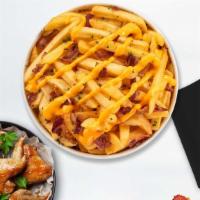 Bacon Cheese Fries · Idaho potato fries cooked until golden brown & garnished with salt, garlic, cheese, and bacon.