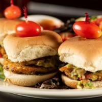Veggie Sliders · Homemade black bean and squash patties topped with guacamole and vegan chipotle aioli. Serve...