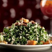 Kale Caesar Salad · Kale, crispy bacon, tossed savory croutons, parmesan cheese, and Caesar dressing.