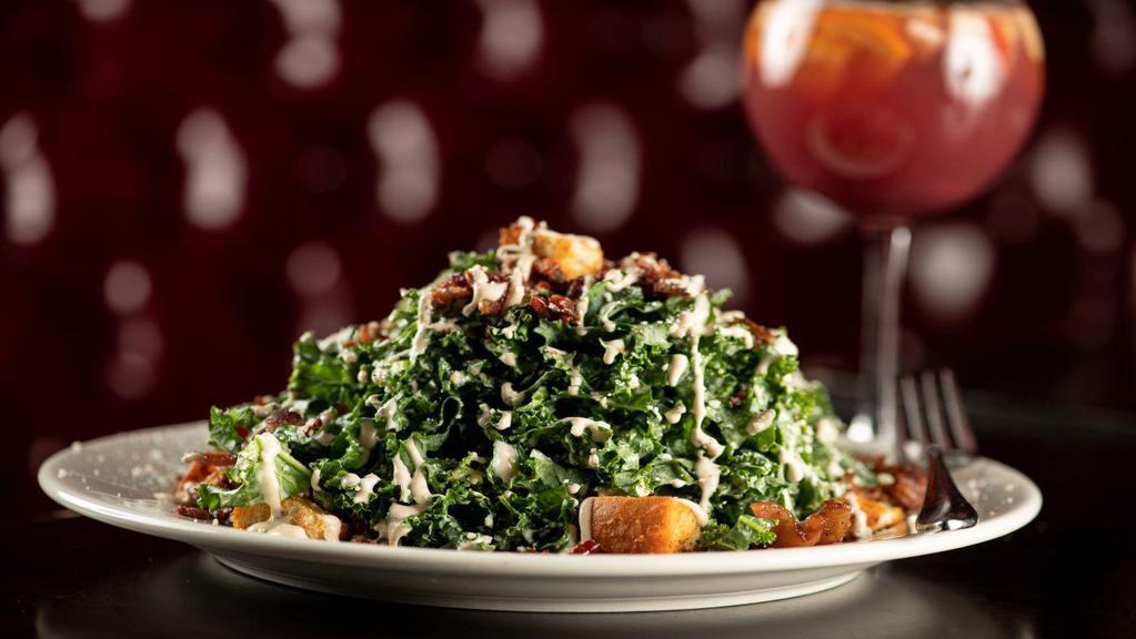 Kale Caesar Salad · Kale, crispy bacon, tossed savory croutons, parmesan cheese, and Caesar dressing.