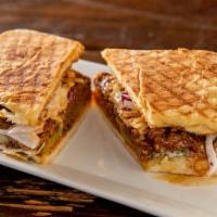 Pulled Pork Panini · With creamy cole slaw, barbeque sauce and pickles.