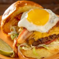 Breakfast Burger · Topped with hickory smoked bacon, cheddar cheese, sunny side up egg and homemade aioli. Serv...