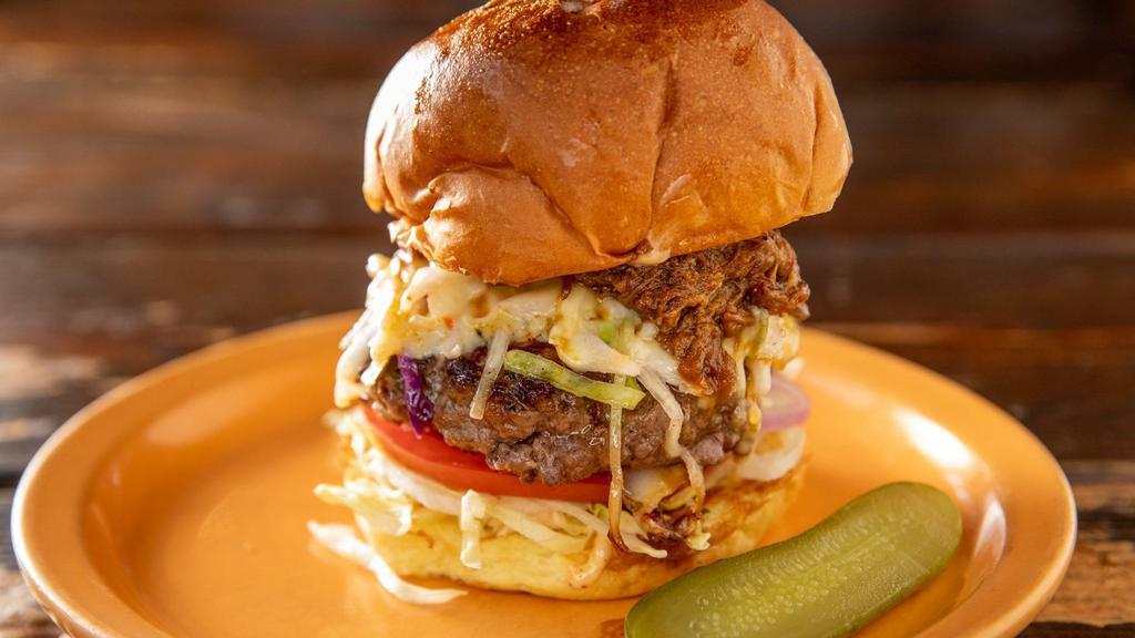 Carolina Burger · Topped with slow-cooked pulled pork, pepper jack cheese and homemade coleslaw. Served with green leaf lettuce, beefsteak tomato, red onion, pickle.