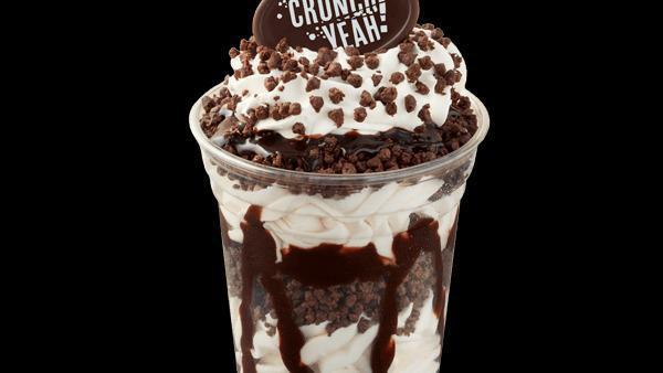 Crunchies Sundae Dasher® · Vanilla soft ice cream with layers of Crunchies and fudge topped with whipped cream and a chocolate medallion.