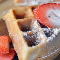 Waffles House Made Belgium Style · House-made Belgium style waffles with powdered sugar and strawberries with a dollop of whipp...