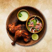 Charred Tandoori Chicken · Chicken pieces marinated in yogurt and powdered spices then char grilled in clay oven