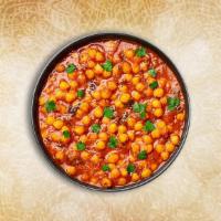 Tangy Chickpea Curry · Slow cooked chickpea cooked with onions, ginger, garlic and seasoned with fresh Indian herbs...