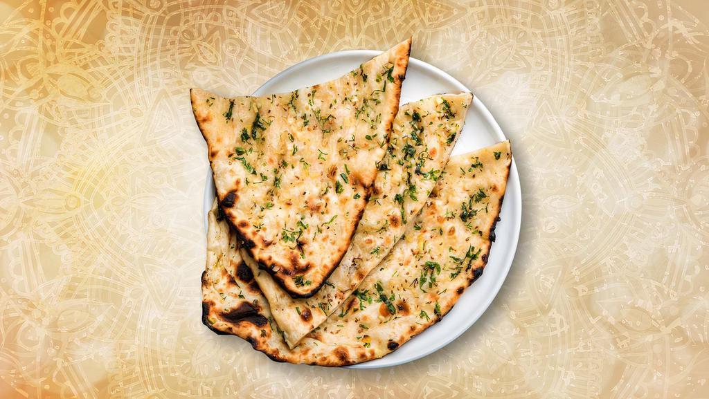 Garlic Blast Naan · Fresh made leavened dough loaded with fine chopped garlic and baked in a traditional coal oven.