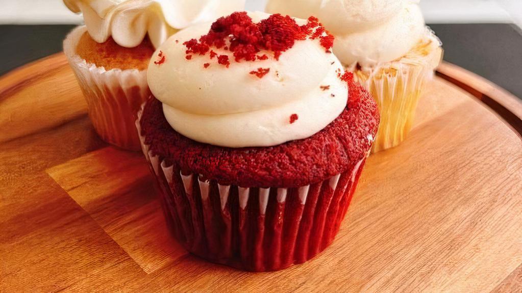 Rich Red Velvet · Red velvet cake filled & topped with cream cheese buttercream & cake crumbs.